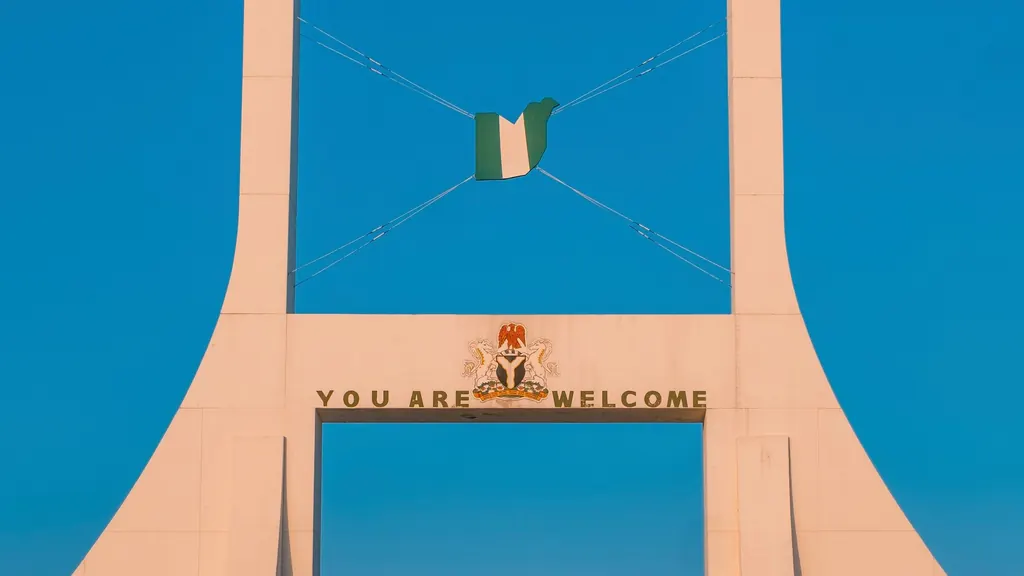 The Abuja City Gate under a clear blue sky