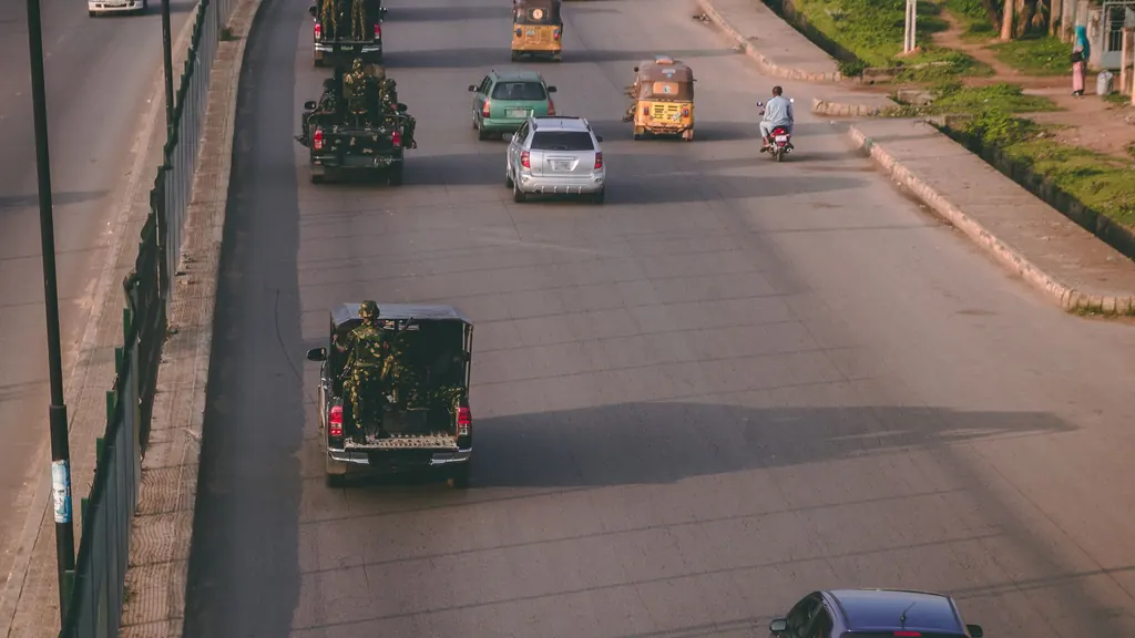 Aerial view of a busy Abuja road with cars and trucks at twilight