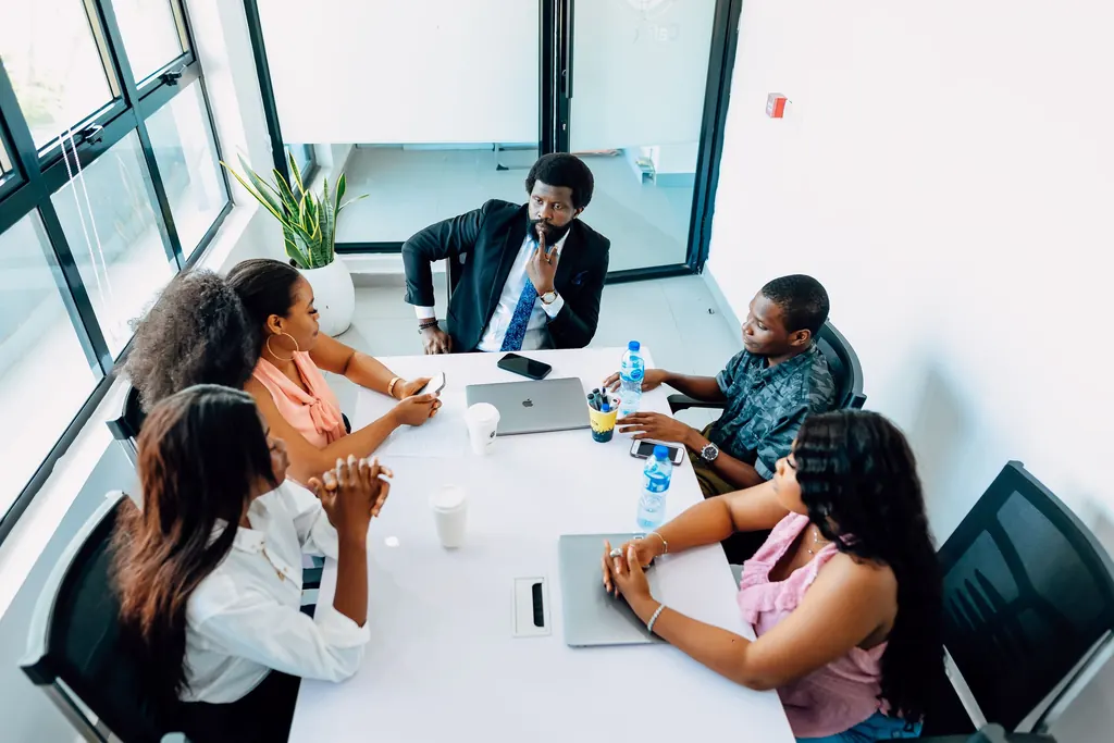 Professionals in a business discussion in a modern Nigerian office