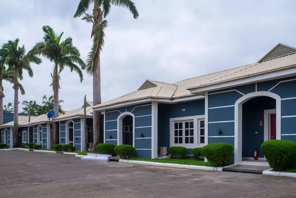 Modern apartments framed by palm trees in Abuja